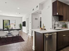 Los Angeles apartment for rent - Tiled kitchen with stainless steel appliances and view of hardwood floored living room and balcony.