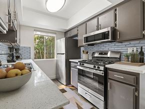 Sherman Oaks apartment for rent - Tiled kitchen with stainless steel oven, microwave, and fridge.