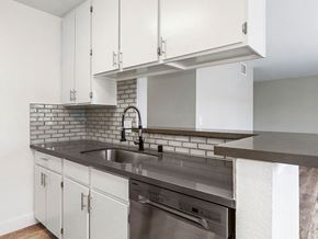 Sherman Oaks apartment for rent - White tiled kitchen with stainless steel fixtures.