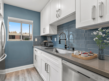 Studio City apartment for rent - A kitchen with white cabinets and a blue wall.