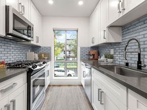 Los Angeles apartment for rent - Blue tiled kitchen with stainless steel microwave, oven, and fixtures.
