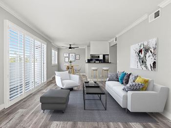 Living room with hardwood floor and large windows for natural light.