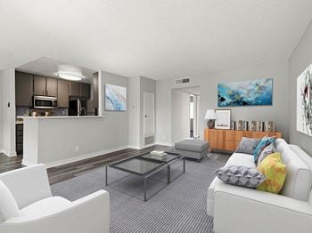 Living room with hardwood floors and view of kitchen.
