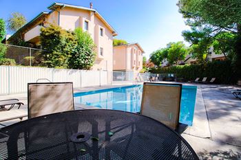 View of seating area by the pool at olive view gardens.