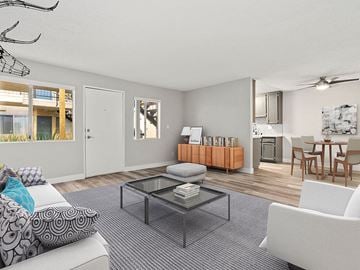 Reseda apartment for rent - A living room with a grey carpet and a glass coffee table.