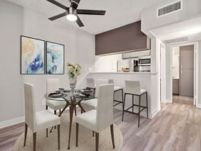 Reseda apartment for rent - Dining room with view of ceiling fan and bar seating in kitchen.