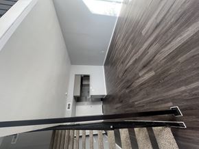 San Antonio townhouse for rent - A staircase with a wooden handrail and a carpeted runner.