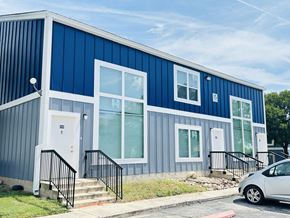 San Antonio townhouse for rent - A blue and white building with a car parked in front.