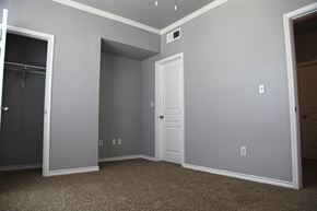 San Antonio townhouse for rent - a bedroom with grey walls and a closet and a door