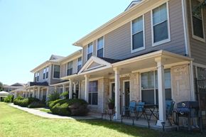 San Antonio townhouse for rent - a row of houses with tables and chairs in front of them
