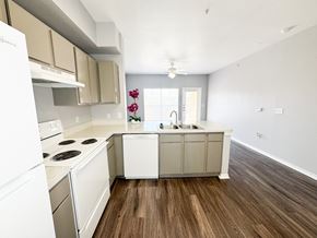 San Antonio apartment for rent - A kitchen with white appliances and wooden floors.