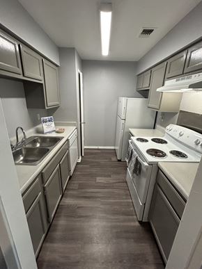 San Antonio townhouse for rent - A kitchen with white appliances and a brown floor.