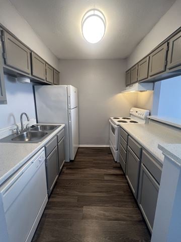 San Antonio townhouse for rent - A kitchen with white cabinets and a white fridge.