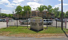 San Antonio apartment for rent - a dumpster in front of a fence and an apartment building