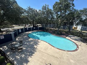 San Antonio townhouse for rent - A round above ground pool with a table and chairs around it.