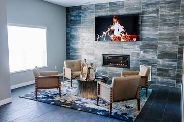 Rochester apartment for rent - a living room with a fireplace and chairs