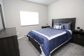 Aberdeen apartment for rent - A bedroom with a bed, nightstand, and window.