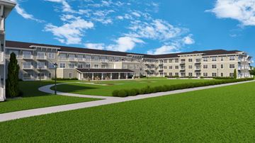 Rochester apartment for rent - A large building with a green lawn in front.