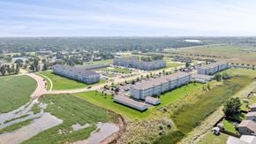 Aberdeen apartment for rent - A large building complex surrounded by a green field.
