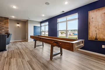 Brookings apartment for rent - a pool table in a living room with a blue wall