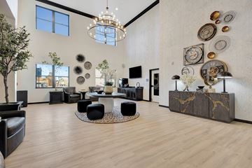 Cheyenne apartment for rent - A modern living room with a large circular table and a chandelier.