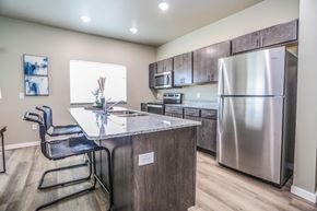 Aberdeen apartment for rent - A kitchen with a stainless steel refrigerator and a granite countertop.
