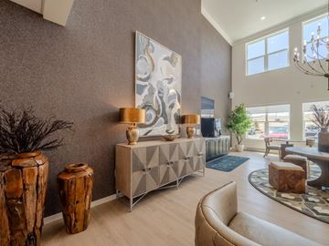 Gillette apartment for rent - A living room with a large abstract painting on the wall, a wooden side table, and a beige sofa.