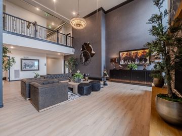 Spearfish apartment for rent - A modern living room with a wooden floor and a large painting on the wall.