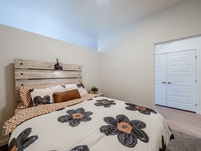 Gillette apartment for rent - A bedroom with a bed, pillows, and a wooden headboard.