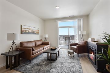 Rochester apartment for rent - A living room with a fireplace and a painting on the wall.
