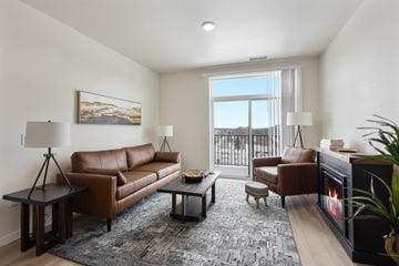 Spearfish apartment for rent - A living room with a fireplace and a painting on the wall.
