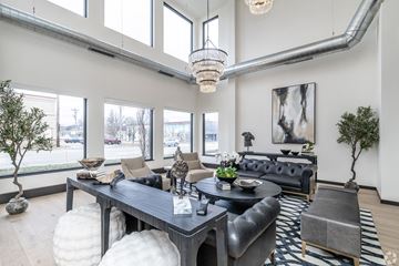 Gillette apartment for rent - A modern living room with a black leather couch and a wooden coffee table.