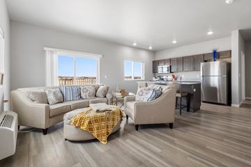 Brookings apartment for rent - a living room with couches and chairs in front of a kitchen with a