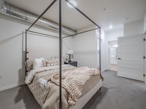 Casper apartment for rent - A bedroom with a four poster bed and a carpeted floor.