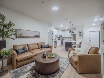 Casper apartment for rent - A living room with a brown leather couch and a coffee table in the center.