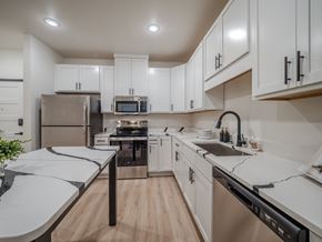 Casper apartment for rent - A modern kitchen with white cabinets and stainless steel appliances.