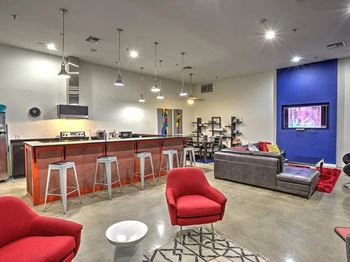 A lobby with a bar and a living room