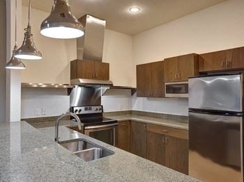 A kitchen with granite counter tops and stainless steel appliances