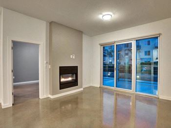 A living room with a fireplace and a large window