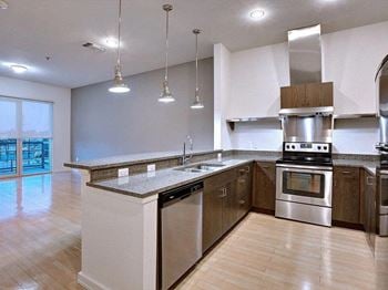 A kitchen with stainless steel appliances and a counter top