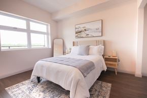 Cambridge apartment for rent - A bedroom with a large bed and a painting on the wall.