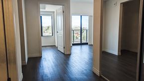 Kitchener apartment for rent - A room with wooden floors and white walls.