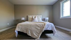 Ingersoll townhouse for rent - a bedroom with a bed and two windows