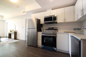 Cambridge apartment for rent - A modern kitchen with a refrigerator, oven, and microwave.