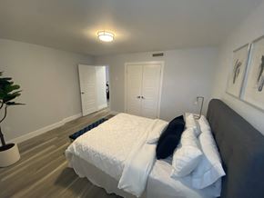 Waterloo apartment for rent - a bedroom with a large bed and a door to a bathroom