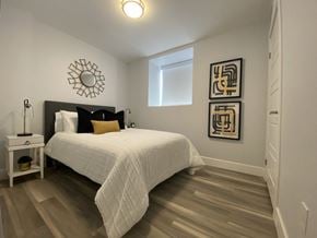 Waterloo apartment for rent - a bedroom with a large white bed and a window