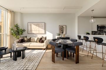 Jersey City apartment for rent - A modern living room with a dining table set for four.