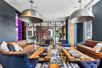 Jersey City apartment for rent - A modern living room with a large sectional sofa and a coffee table.
