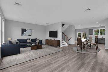 Montvale apartment for rent - A modern living room with a dark blue sofa and wooden flooring.