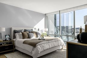 Secaucus apartment for rent - Interior photo of a typical bedroom in an apartment at RVR showing a queen sized bed with 2 night stands with dramatic floor to ceiling windows.,